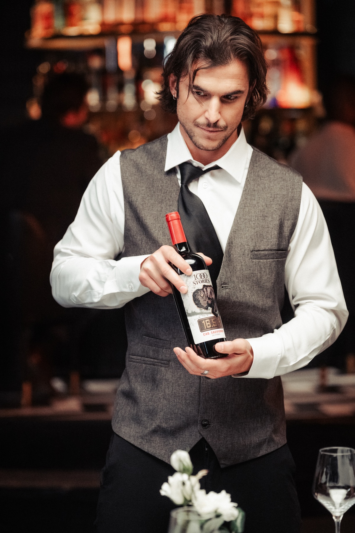 Sommelier presenting a bottle of 1000 Stories wine